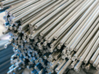 A bundle of stainless steel bars. Large industrial warehouse metal
