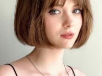 a-beautiful-mouse-brown-French-bob-with-a-fringe-and-a-lot-of-volume-is-a-cool-and-chic-idea-for-everyone-who-loves-classics