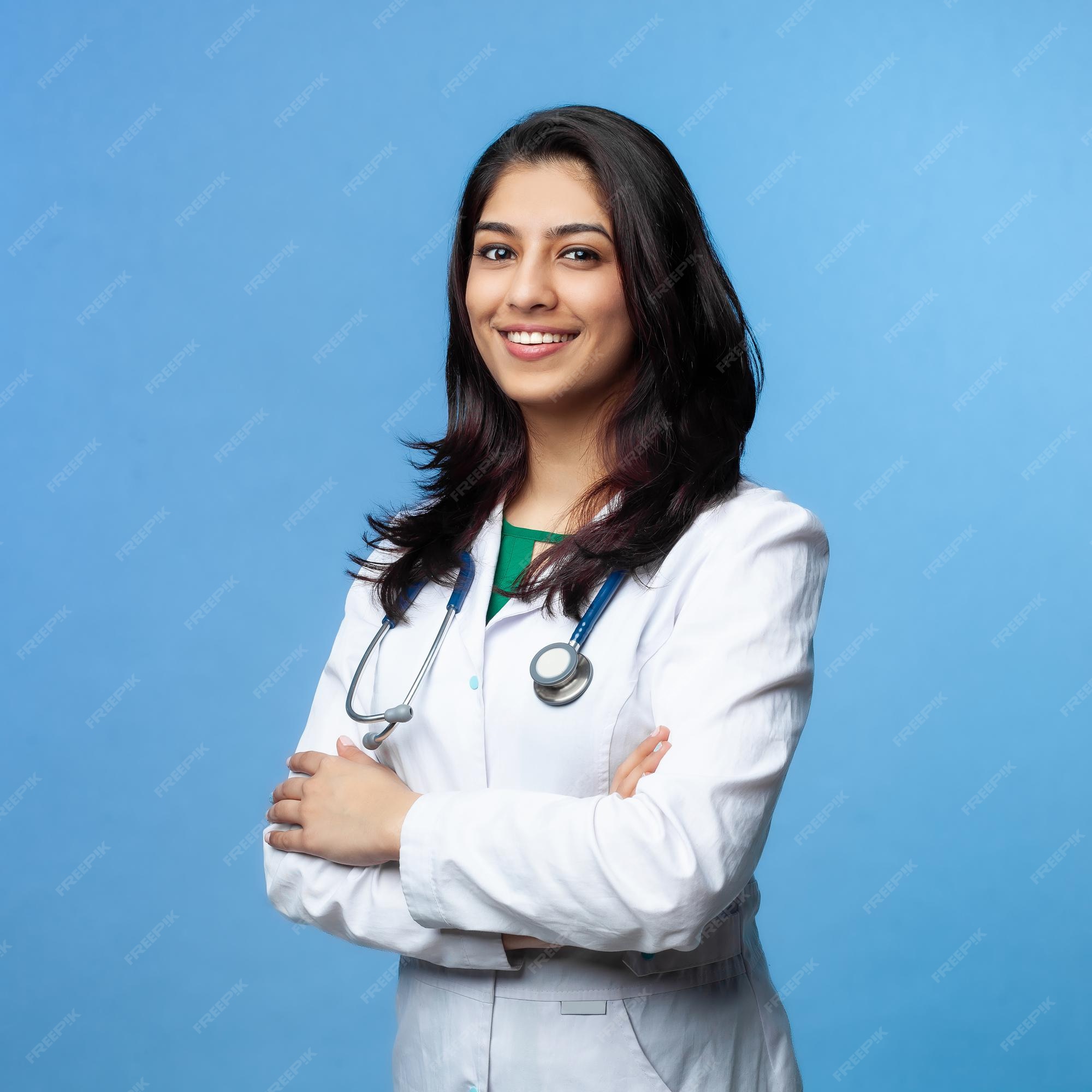 An Indian female doctor smiling in a medical environment