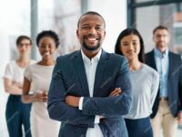 professional-diverse-successful-business-team-smiling-standing-together-office-happy-formal-multiracial-corporate-staff-bank-workers-businesspeople-looking-camera_590464-77422